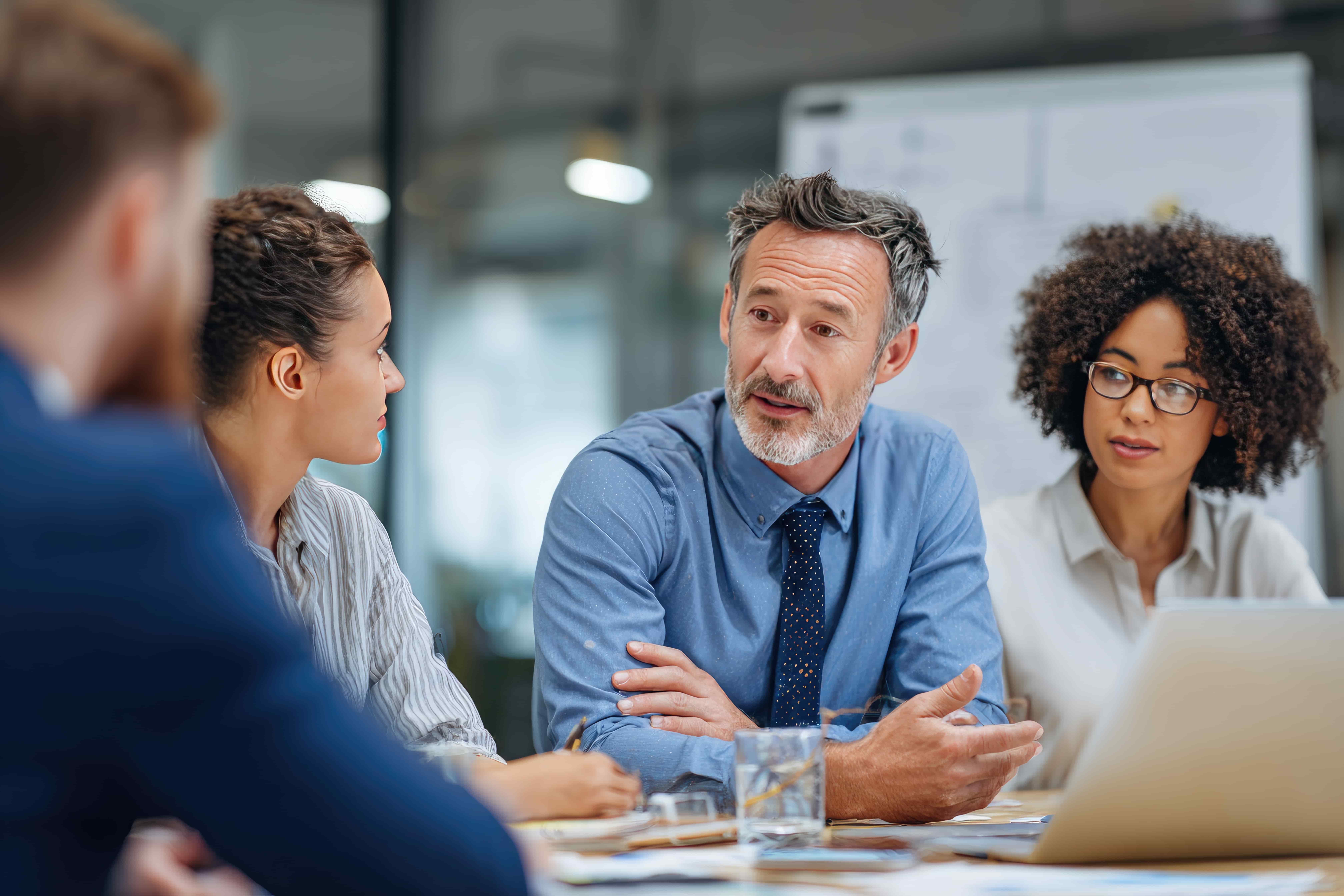 Businessman leads small team meeting