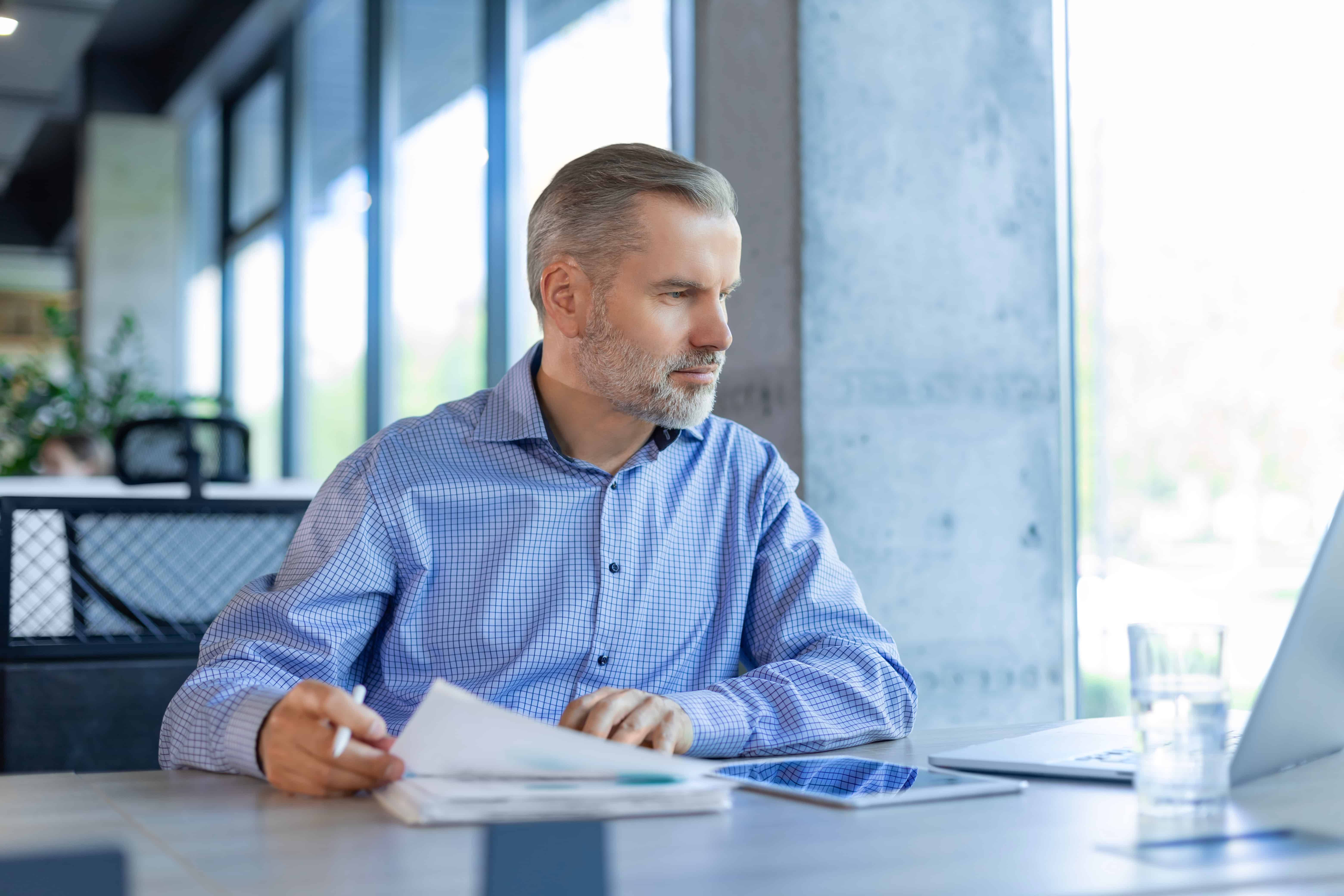 Businessman working with documents using laptop